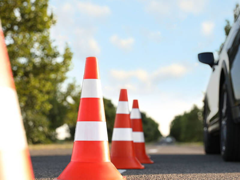 Liikennekartioita auton lähellä ulkona.